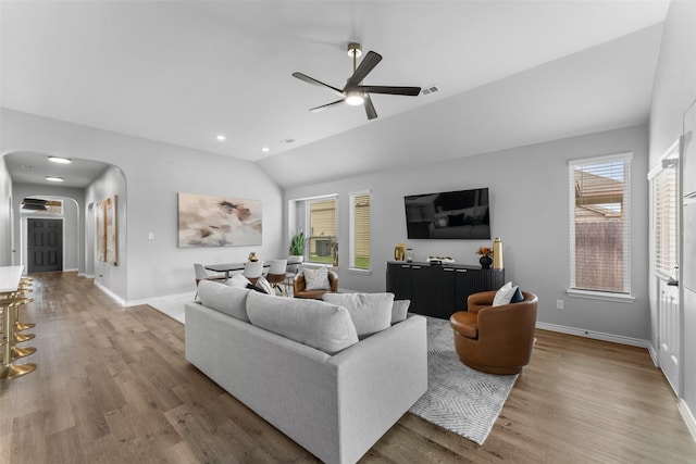 1412 Inks Dr, Desoto, TX 75115 - living room with lofted ceiling, arched walkways, plenty of natural light, and wood finished floors