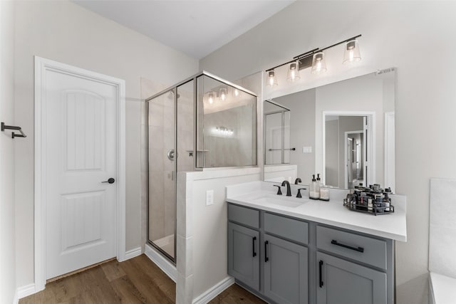 1412 Inks Dr, Desoto, TX 75115 - full bathroom featuring a stall shower, wood finished floors, and vanity
