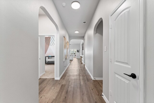 1412 Inks Dr, Desoto, TX 75115 - corridor with wood finished floors, arched walkways, and baseboards