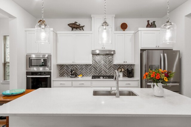 5415 Waterloo Dr, Sachse, TX 75048 - kitchen featuring stainless steel appliances, a sink, under cabinet range hood, and light countertops