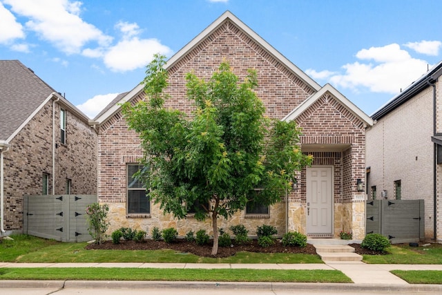 5415 Waterloo Dr, Sachse, TX 75048 - view of front facade featuring a gate, brick siding, and stone siding