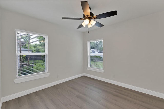 3022 50th St, Dallas, TX 75216 - spare room with wood finished floors, baseboards, and a ceiling fan