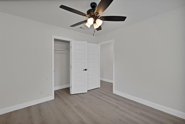 3022 50th St, Dallas, TX 75216 - unfurnished bedroom featuring wood finished floors, baseboards, a closet, and ceiling fan