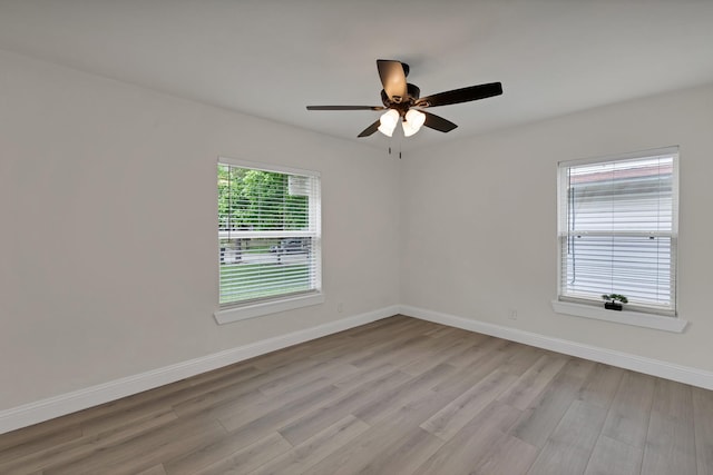 3022 50th St, Dallas, TX 75216 - unfurnished room with light wood-style floors, a ceiling fan, and baseboards