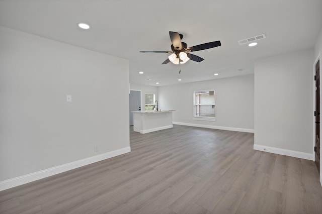 3022 50th St, Dallas, TX 75216 - unfurnished living room featuring ceiling fan, baseboards, wood finished floors, a sink, and recessed lighting