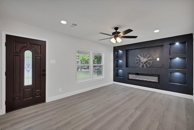 3022 50th St, Dallas, TX 75216 - foyer entrance with baseboards, wood finished floors, a glass covered fireplace, a ceiling fan, and recessed lighting