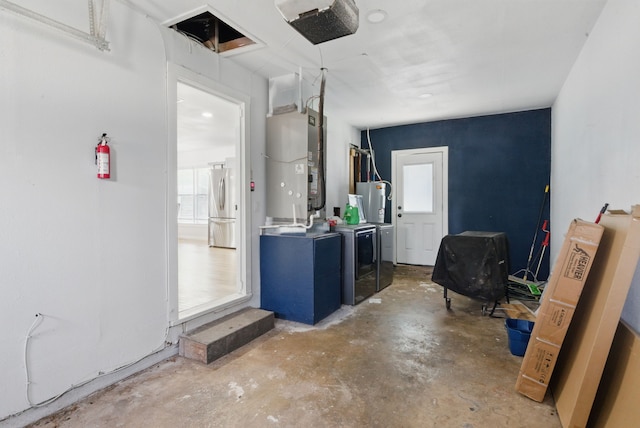 613 Crestview Dr, Granbury, TX 76048 - garage with washer and clothes dryer, freestanding refrigerator, heating unit, a garage door opener, and water heater