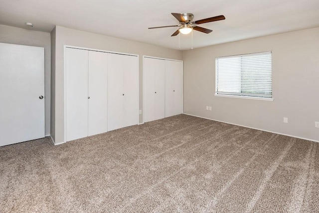 745 Cambridge Dr, Plano, TX 75023 - unfurnished bedroom featuring carpet floors, two closets, and a ceiling fan