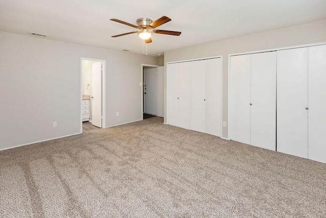 745 Cambridge Dr, Plano, TX 75023 - unfurnished bedroom with carpet flooring, multiple closets, ceiling fan, and connected bathroom