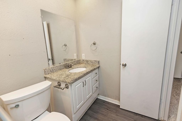 745 Cambridge Dr, Plano, TX 75023 - half bath with toilet, vanity, wood finished floors, and baseboards