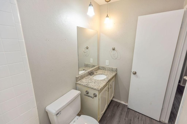 745 Cambridge Dr, Plano, TX 75023 - bathroom featuring wood finished floors, vanity, and toilet