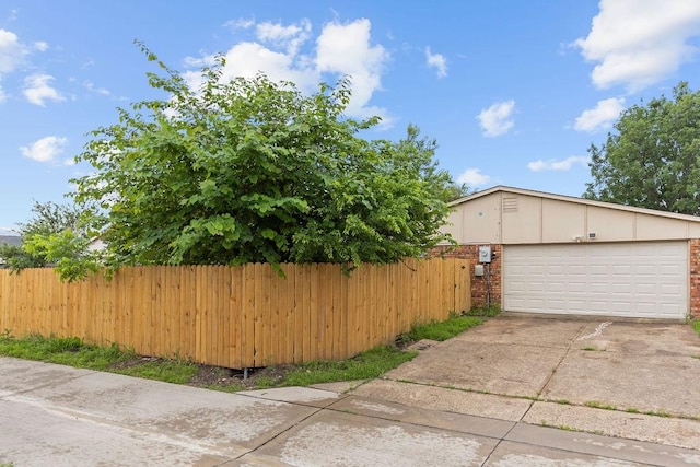 745 Cambridge Dr, Plano, TX 75023 - view of home's exterior with fence, brick siding, and driveway