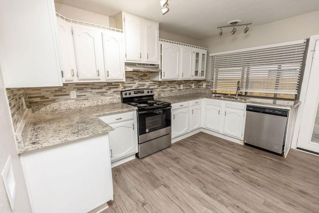 745 Cambridge Dr, Plano, TX 75023 - kitchen with appliances with stainless steel finishes, a sink, white cabinetry, and backsplash