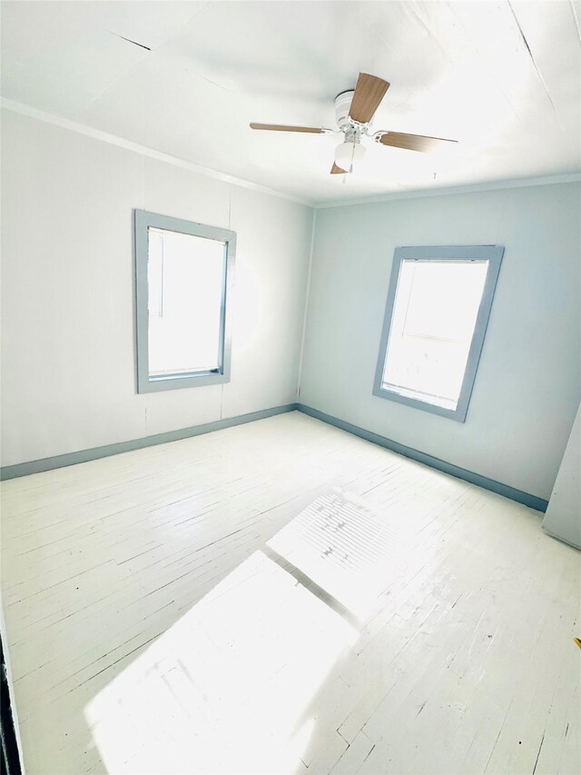 301 Beckham St E, Sulphur Springs, TX 75482 - unfurnished room featuring healthy amount of natural light, light wood-type flooring, baseboards, ornamental molding, and a ceiling fan