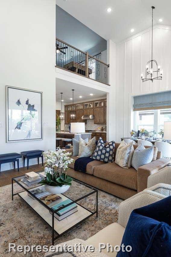 2408 Plumeria Ln, Celina, TX 75009 - living area with a high ceiling, a chandelier, wood finished floors, and recessed lighting