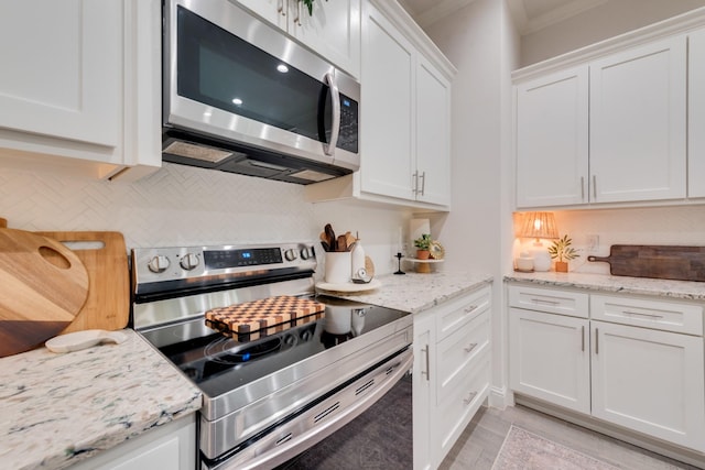 391 E Lamar St, Royse City, TX 75189 - kitchen featuring appliances with stainless steel finishes, white cabinets, backsplash, light wood-style floors, and light stone countertops