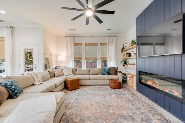 391 E Lamar St, Royse City, TX 75189 - living area with a glass covered fireplace, ornamental molding, and a ceiling fan
