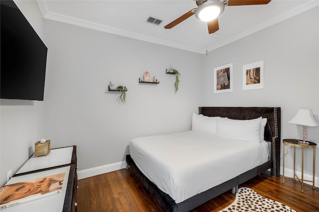 bedroom featuring wood finished floors, crown molding, baseboards, and a ceiling fan