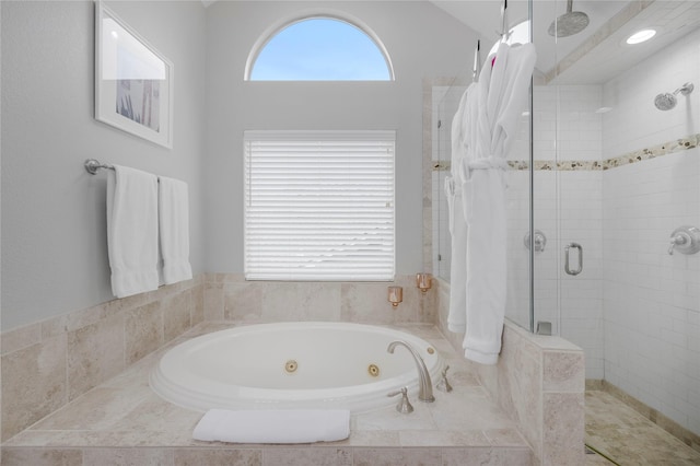 full bath featuring a shower stall and a tub with jets