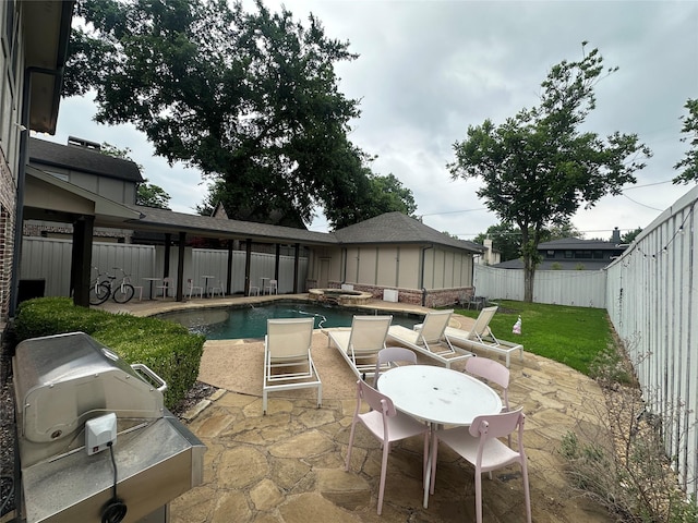 view of swimming pool with a patio area, a pool with connected hot tub, and a grill