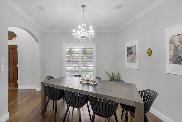 dining space with arched walkways, a chandelier, baseboards, dark wood-type flooring, and ornamental molding