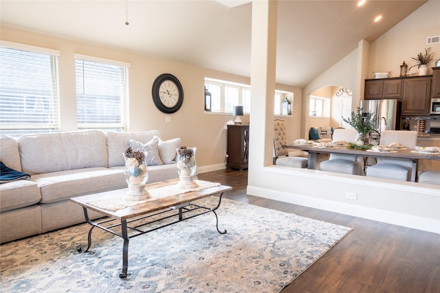 3031 Concourse Dr, Royse City, TX 75189 - living room featuring dark wood-type flooring, baseboards, arched walkways, and high vaulted ceiling