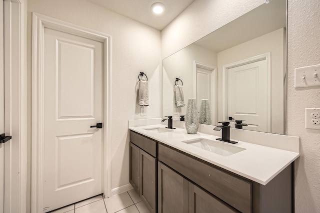 706 Spur Rdg, Princeton, TX 75407 - full bathroom featuring tile patterned floors, double vanity, and a textured wall