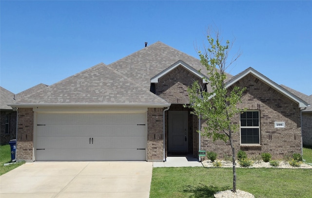 706 Spur Rdg, Princeton, TX 75407 - view of front facade with concrete driveway, a garage, brick siding, and a front lawn