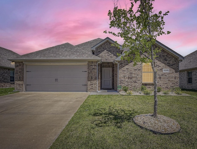 706 Spur Rdg, Princeton, TX 75407 - view of front of house with concrete driveway, a yard, an attached garage, and brick siding