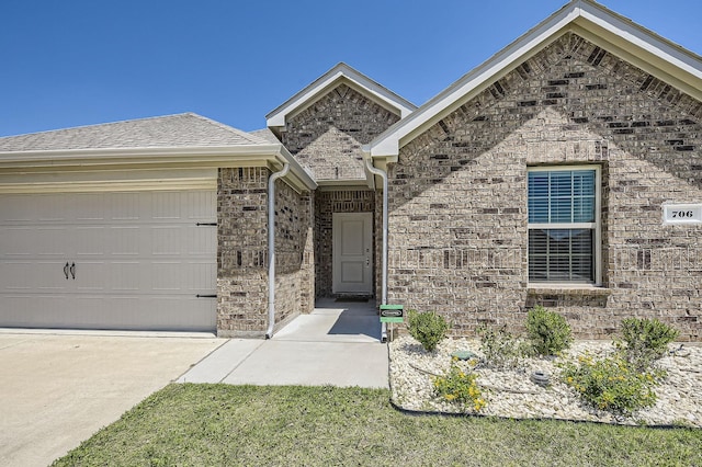 706 Spur Rdg, Princeton, TX 75407 - view of front of home featuring an attached garage, brick siding, and driveway