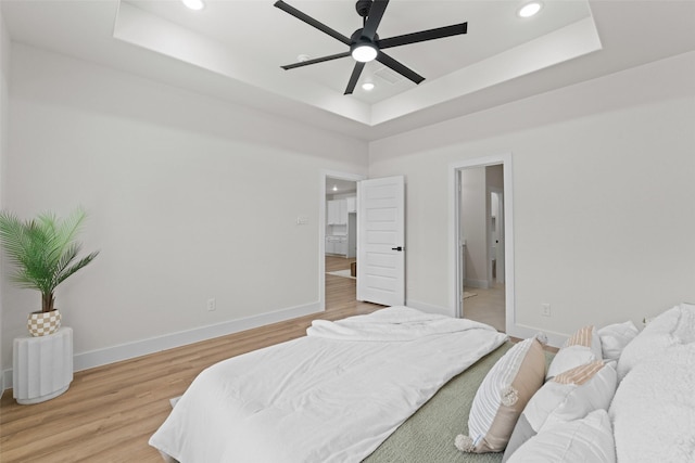 2104 Danner St, Fort Worth, TX 76105 - bedroom featuring a raised ceiling, recessed lighting, light wood-type flooring, and baseboards