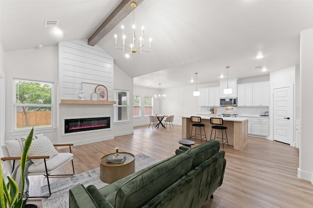 2104 Danner St, Fort Worth, TX 76105 - living area featuring a chandelier, light wood-type flooring, a glass covered fireplace, baseboards, and recessed lighting