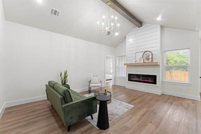 2104 Danner St, Fort Worth, TX 76105 - living room with a chandelier, light wood-type flooring, baseboards, a glass covered fireplace, and recessed lighting