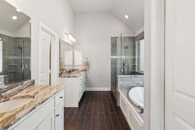 9521 Excursion Dr, Oak Point, TX 75068 - full bathroom with a stall shower, two vanities, recessed lighting, lofted ceiling, and baseboards