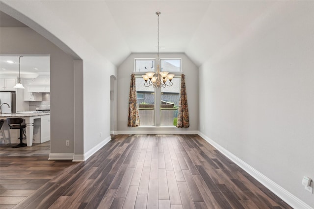 9521 Excursion Dr, Oak Point, TX 75068 - unfurnished dining area with a chandelier, arched walkways, dark wood-style flooring, baseboards, and vaulted ceiling