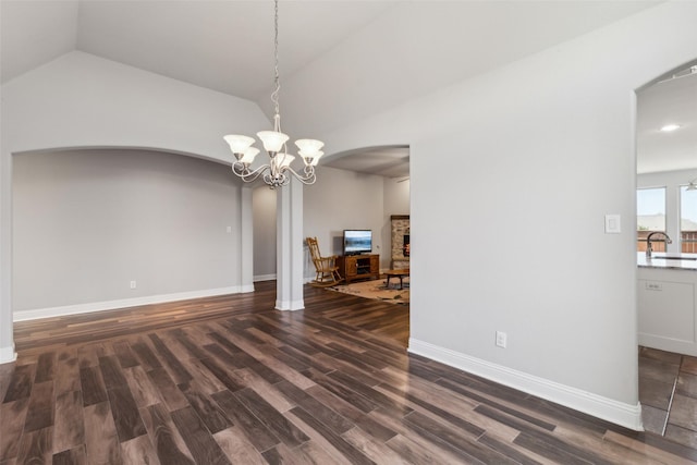 9521 Excursion Dr, Oak Point, TX 75068 - unfurnished dining area with arched walkways, vaulted ceiling, wood finished floors, a chandelier, and baseboards