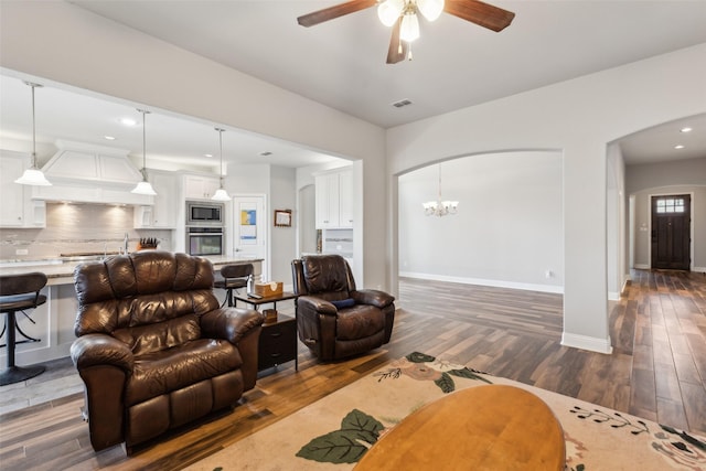9521 Excursion Dr, Oak Point, TX 75068 - living area with arched walkways, dark wood-style flooring, ceiling fan, baseboards, and recessed lighting