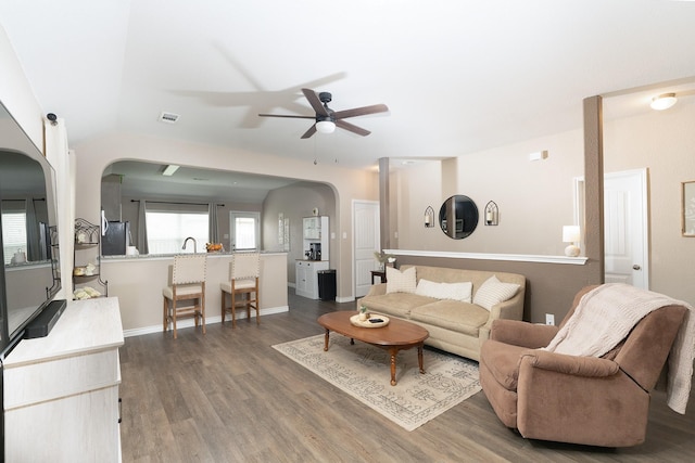1402 Fantail Ln, Ennis, TX 75119 - living room featuring arched walkways, a ceiling fan, wood finished floors, and baseboards
