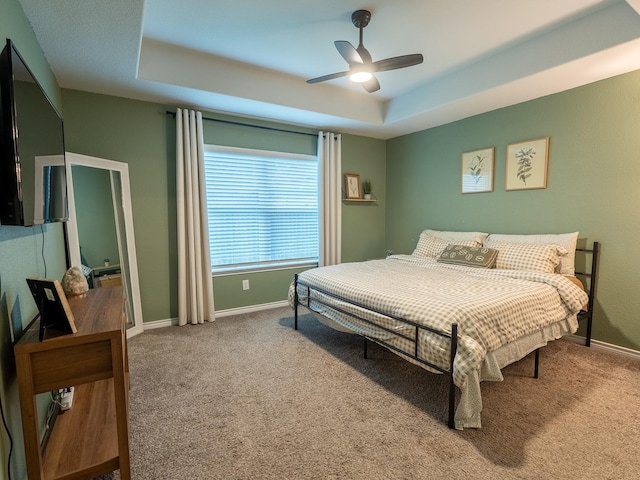1402 Fantail Ln, Ennis, TX 75119 - carpeted bedroom with a tray ceiling, baseboards, and ceiling fan