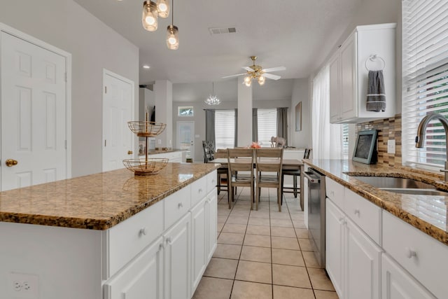 6813 Andress Dr, Fort Worth, TX 76132 - kitchen with a sink, stainless steel dishwasher, a ceiling fan, light tile patterned flooring, and a kitchen island