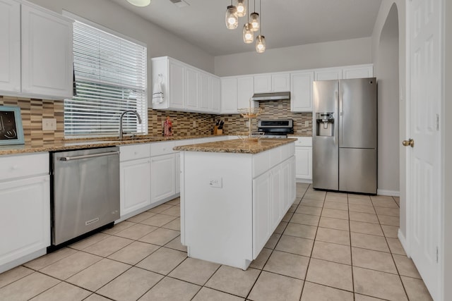 6813 Andress Dr, Fort Worth, TX 76132 - kitchen featuring appliances with stainless steel finishes, under cabinet range hood, light tile patterned flooring, and tasteful backsplash