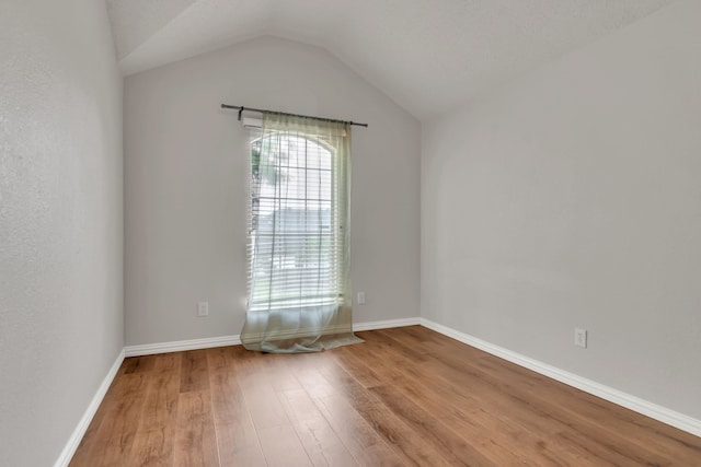 6813 Andress Dr, Fort Worth, TX 76132 - spare room with wood finished floors, lofted ceiling, and baseboards