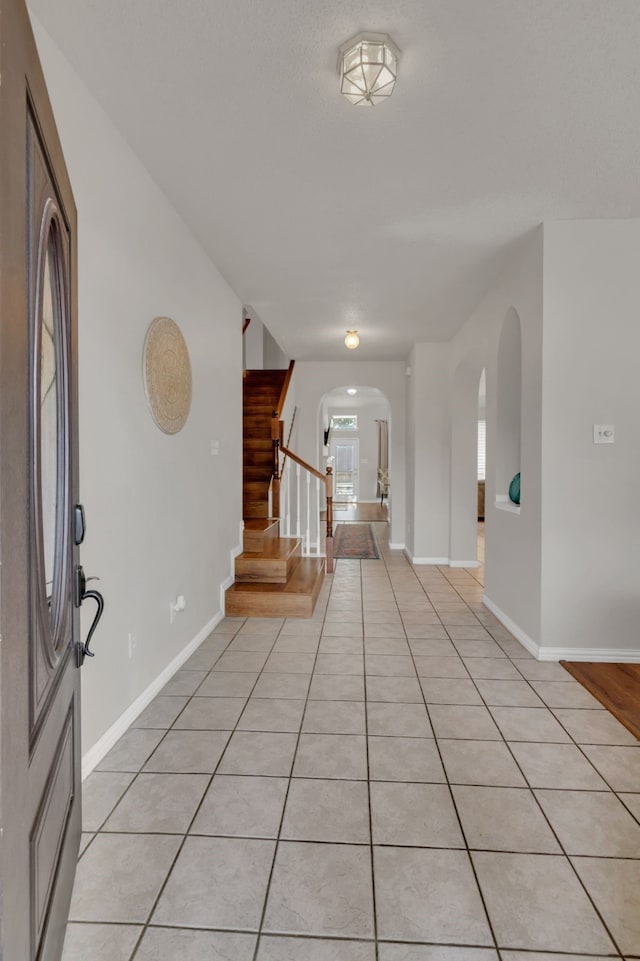 6813 Andress Dr, Fort Worth, TX 76132 - foyer with arched walkways, stairway, and baseboards