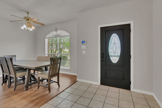 6813 Andress Dr, Fort Worth, TX 76132 - foyer entrance with baseboards, a ceiling fan, light wood-style floors, and a textured ceiling