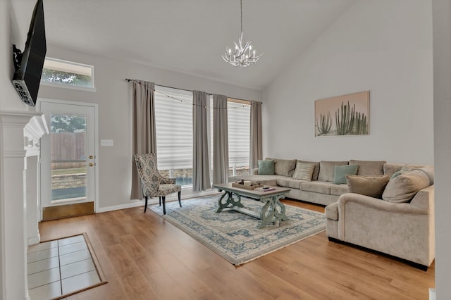 6813 Andress Dr, Fort Worth, TX 76132 - living room with a chandelier, light wood-style flooring, and high vaulted ceiling