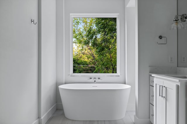 9234 San Fernando Way, Dallas, TX 75218 - full bath featuring plenty of natural light, a freestanding bath, baseboards, and vanity