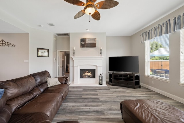 5136 Raisintree Dr, Fort Worth, TX 76244 - living room with wood finished floors, a ceiling fan, and a lit fireplace