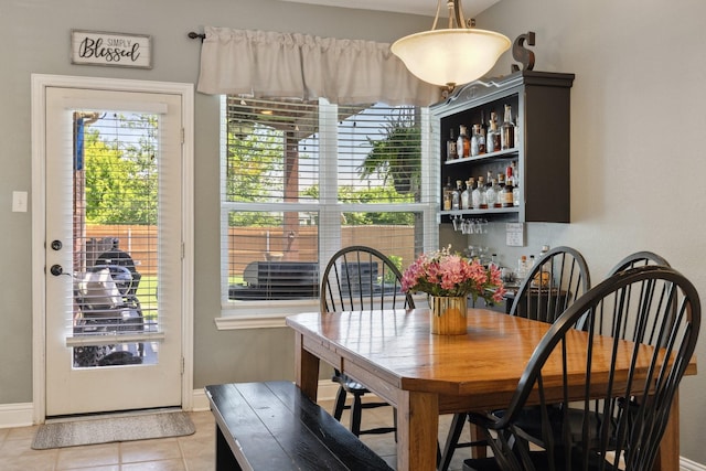 5136 Raisintree Dr, Fort Worth, TX 76244 - dining area with light tile patterned flooring, baseboards, and a dry bar