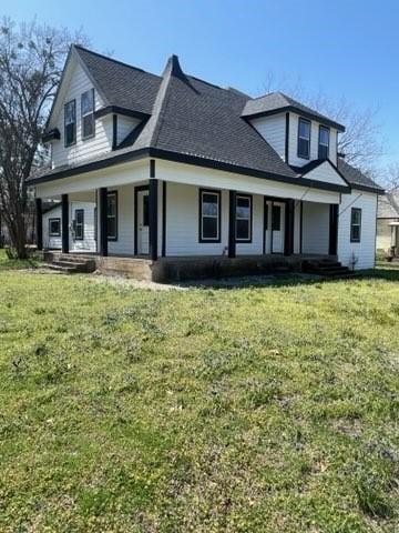 323 E Grand St, Whitewright, TX 75491 - view of front of property featuring covered porch, a front yard, and roof with shingles