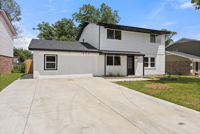 1006 Irene Dr, Mesquite, TX 75149 - view of front of house with a front yard, concrete driveway, and brick siding